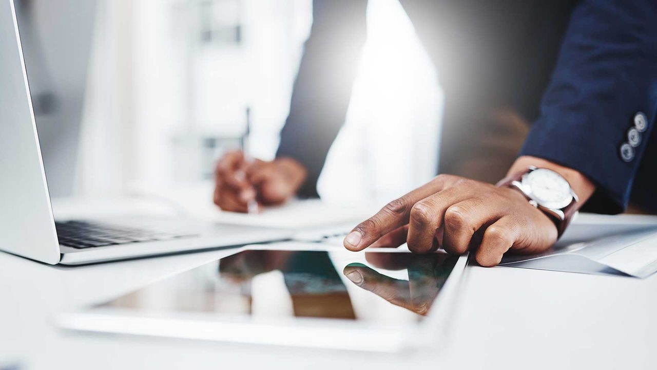 man with finger on tablet